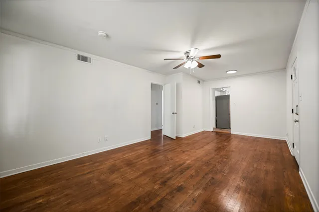 a view of an empty room with a ceiling fan