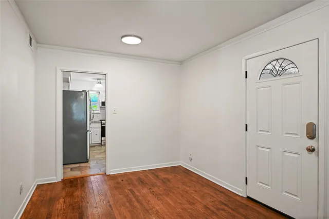 an empty room with wooden floor and closet