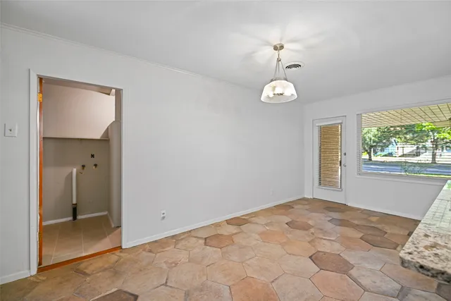 a view of a bedroom with a bed and a window
