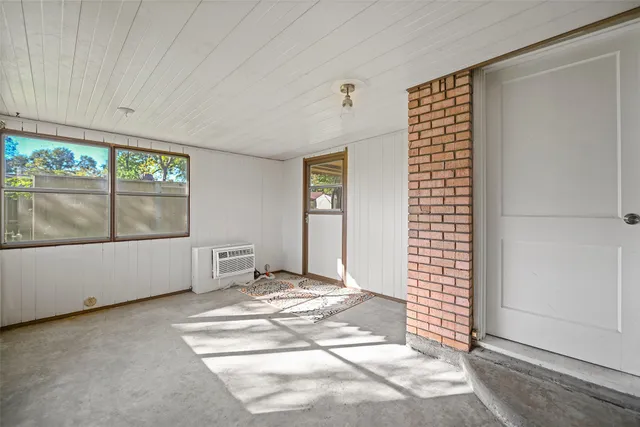 a view of an empty room with window and doors