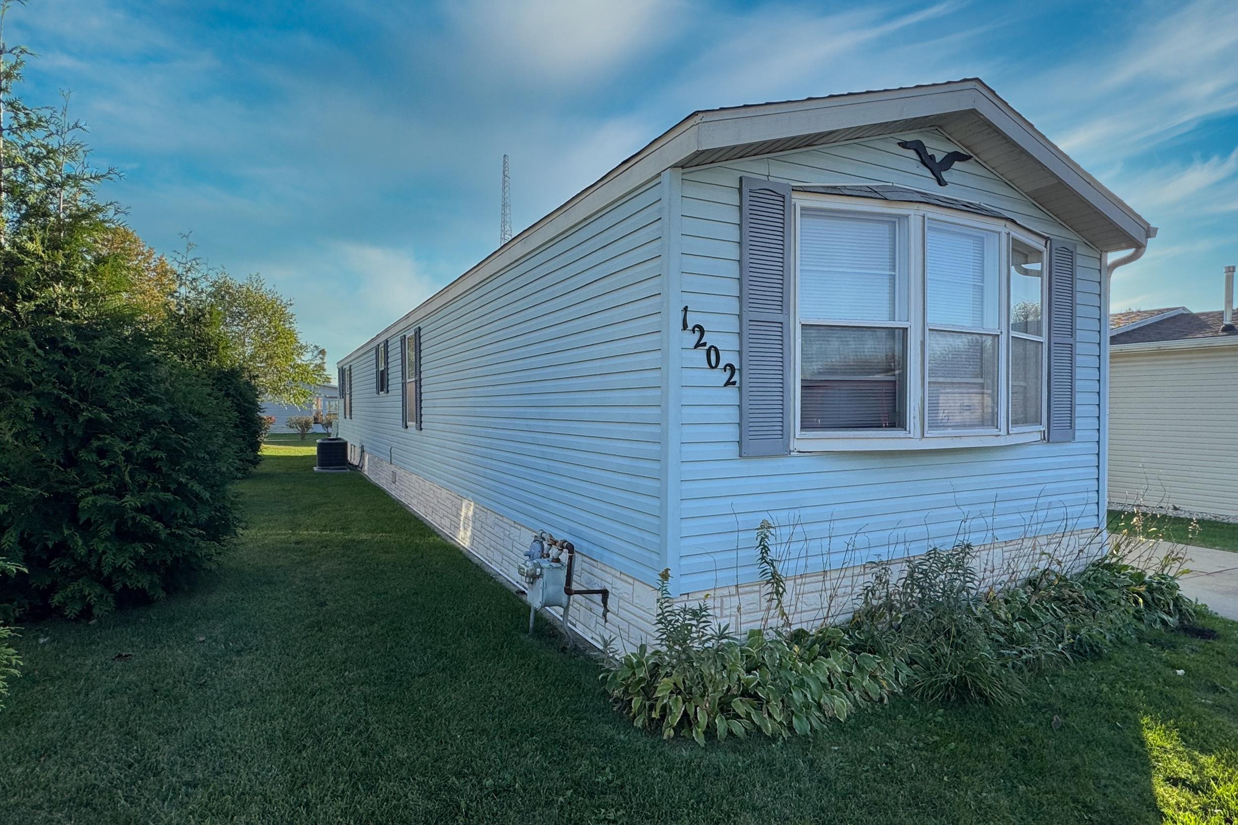 1202 Spring Circle Belvidere, IL 61008 - Photo 11 of 16 a front view of a house with a yard