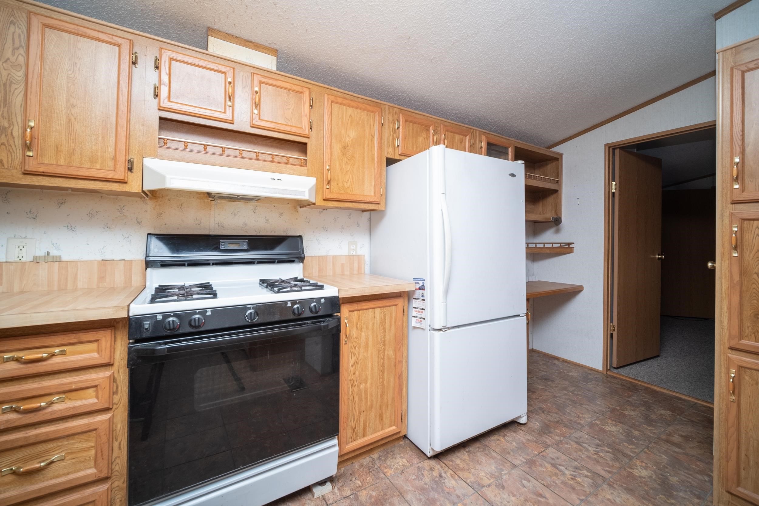 1202 Spring Circle Belvidere, IL 61008 - Photo 6 of 16 a white refrigerator freezer and a stove sitting inside of a kitchen