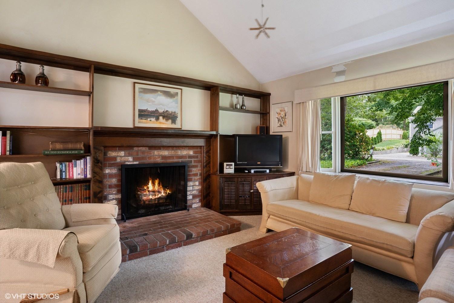 14 Nathan Road Centerville, MA 02632 - Photo 4 of 16 a living room with furniture a flat screen tv and a fireplace
