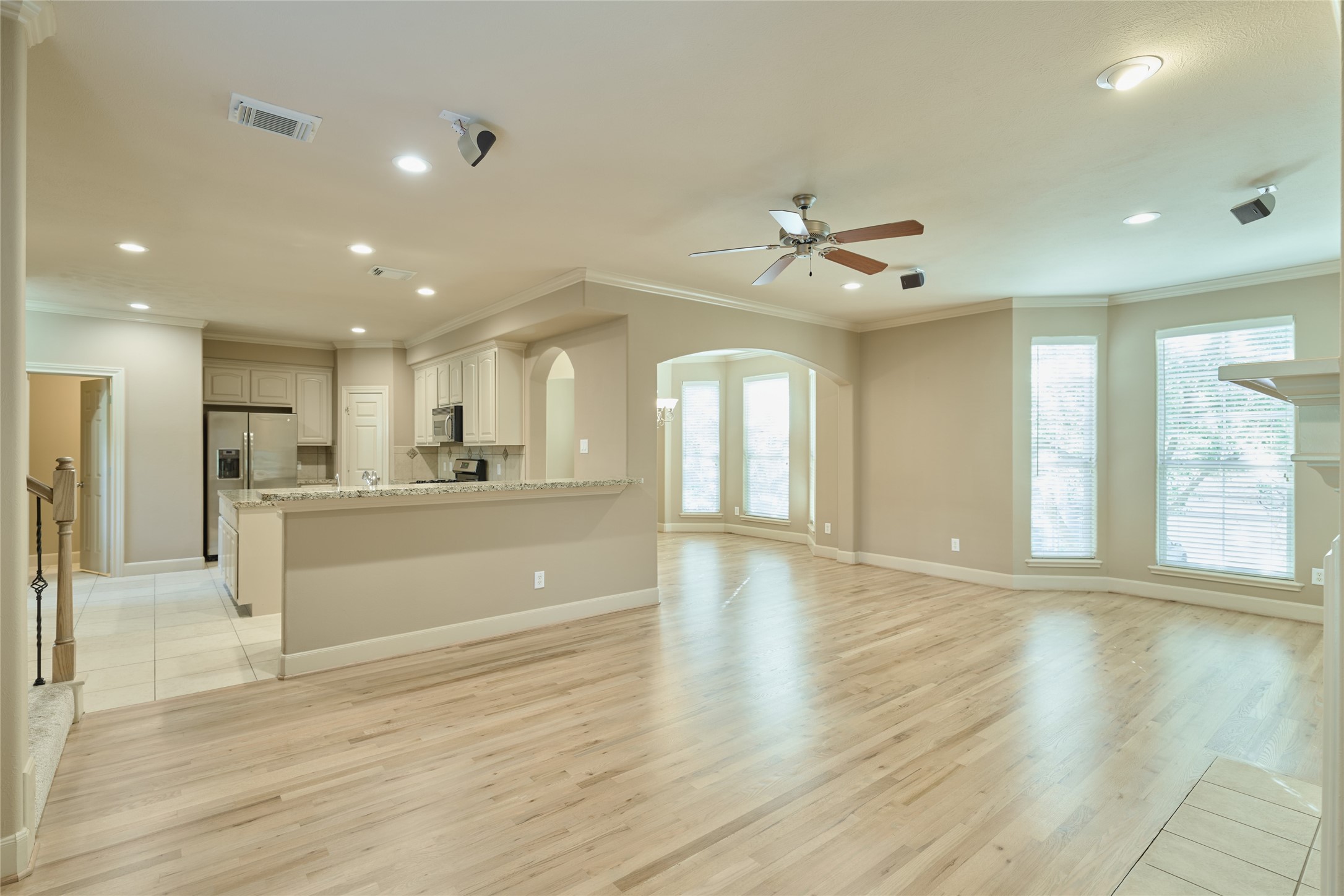 5612 Lacy Street Houston, TX 77007 - Photo 2 of 22 a view of an empty room and kitchen with wooden floor