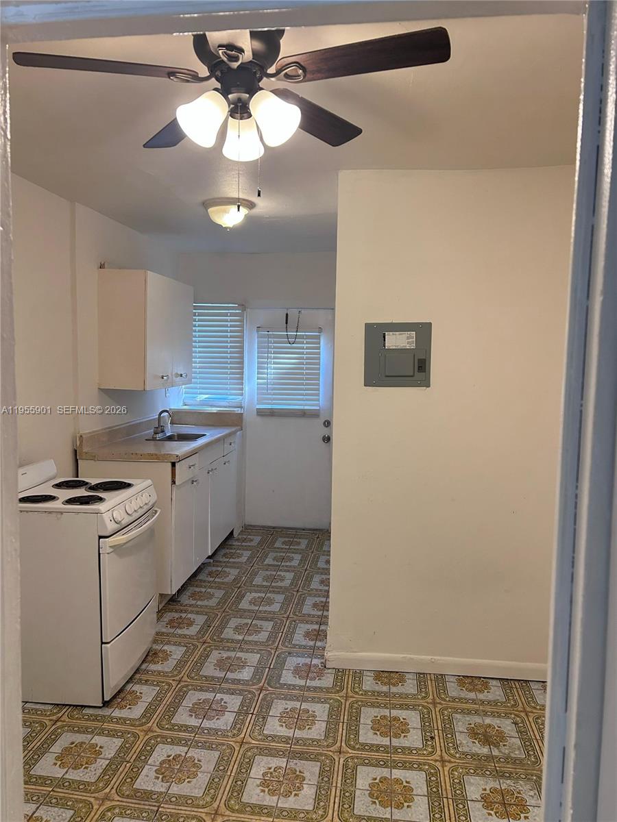 3690 Southwest 14th Street, Unit 1 Miami, FL 33145 - Photo 12 of 13 a kitchen with a stove a sink and cabinets