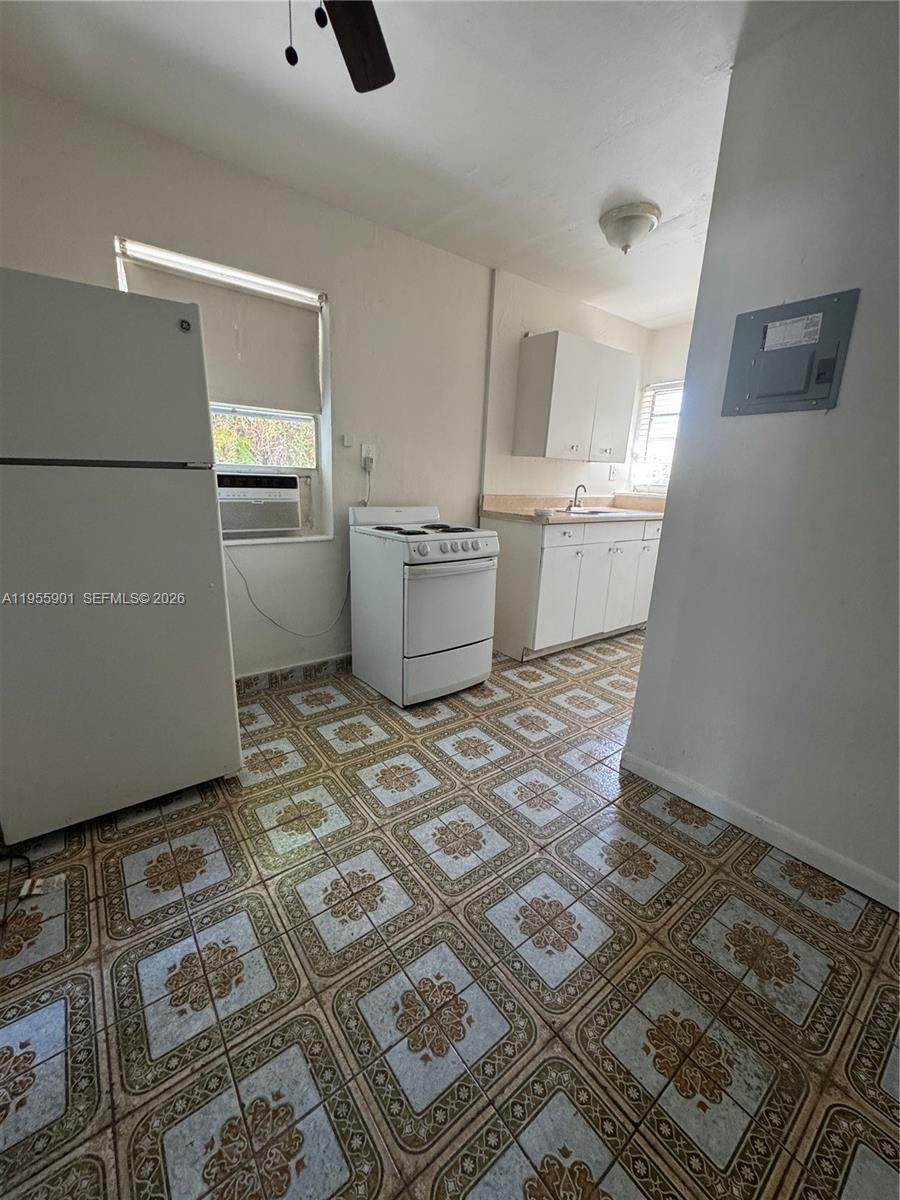 3690 Southwest 14th Street, Unit 1 Miami, FL 33145 - Photo 2 of 13 a room with a couch and a stove top oven