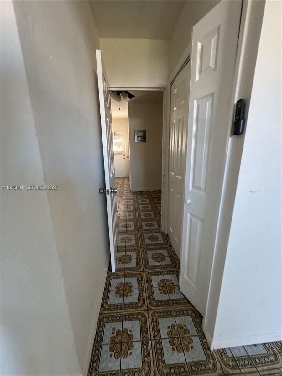 3690 Southwest 14th Street, Unit 1 Miami, FL 33145 - Photo 4 of 13 a view of a hallway with wooden floor and staircase