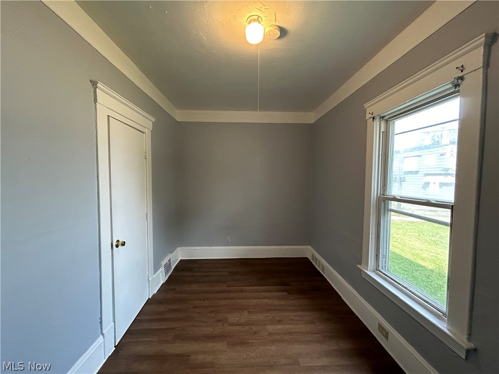 3403 Fulton Road, Unit DOWN Cleveland, OH 44109 - Photo 11 of 18 Empty room with plenty of natural light and dark hardwood / wood-style flooring