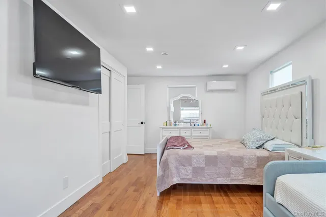 a bedroom with two beds and a closet