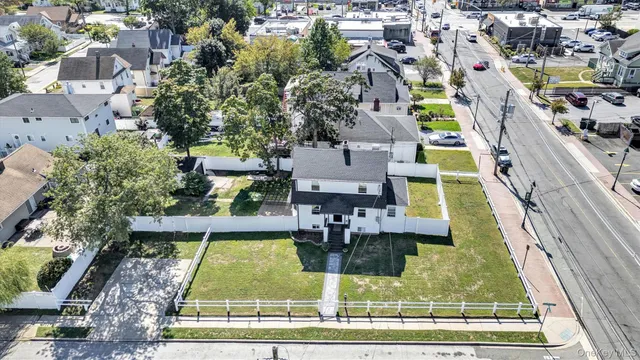 an aerial view of a house with a garden and pool