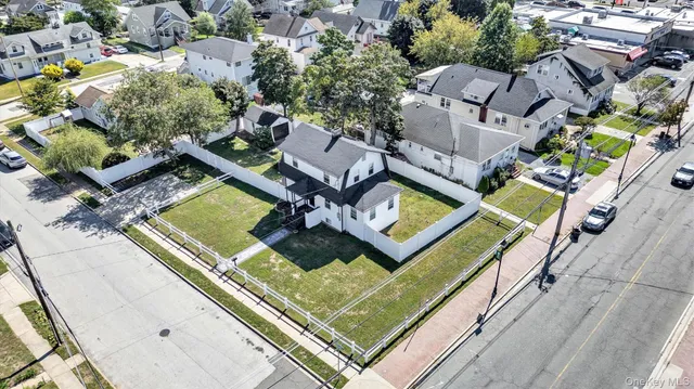 an aerial view of a residential houses with outdoor space