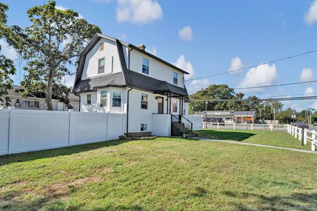 a view of a house with a yard and sitting area
