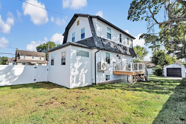 a front view of a house with wooden fence