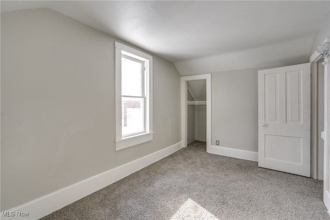 46 Rosenberry Street Alliance, OH 44601 - Photo 26 of 39 Unfurnished bedroom featuring light colored carpet, lofted ceiling, and a closet