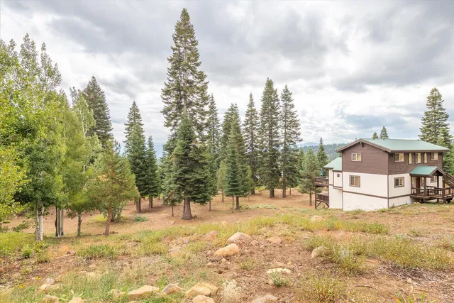 a view of a house with snow on the background