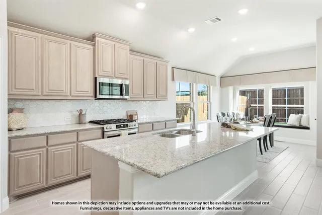 a living room with stainless steel appliances kitchen island granite countertop a sink and chairs