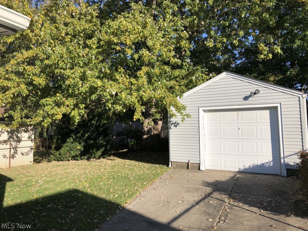 821 Reed Avenue Akron, OH 44306 - Photo 18 of 21 One car garage with electric door opener and concrete drive. The backyard has trees for shade and recreation.