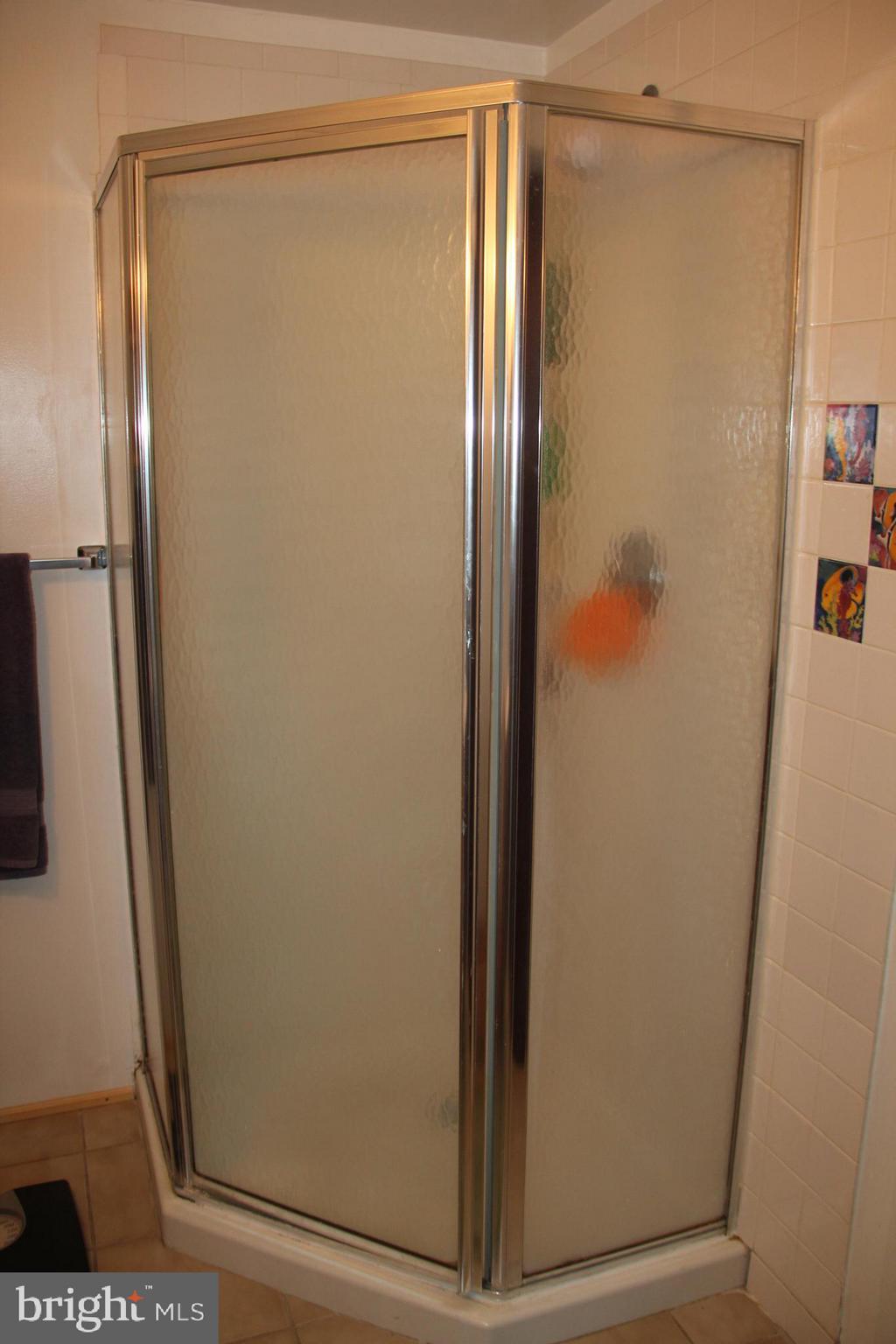 9511 Holiday Manor Road Baltimore, MD 21236 - Photo 24 of 29 a bathroom with a glass shower door