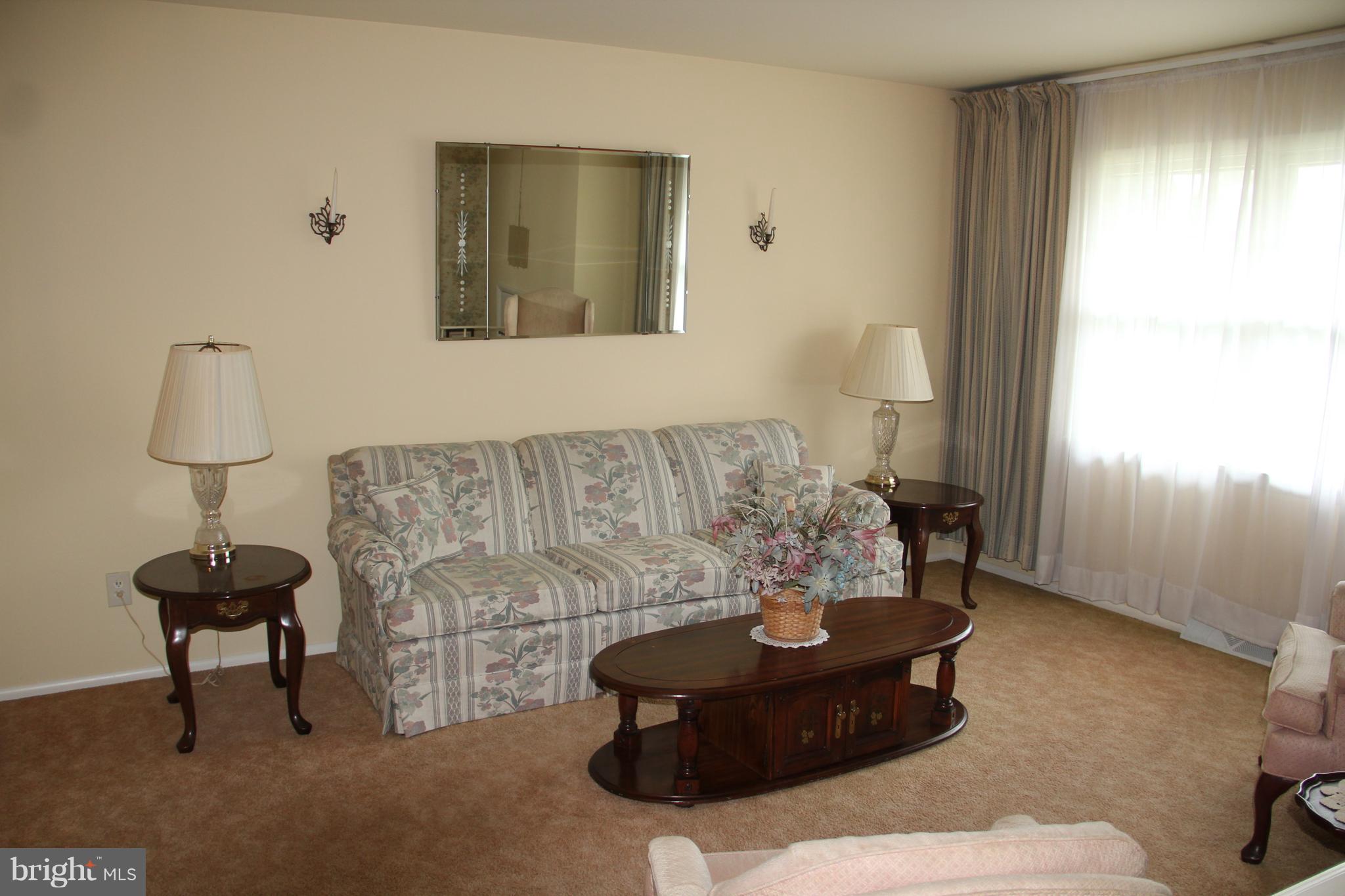 9511 Holiday Manor Road Baltimore, MD 21236 - Photo 4 of 29 a living room with furniture and a painting on the wall