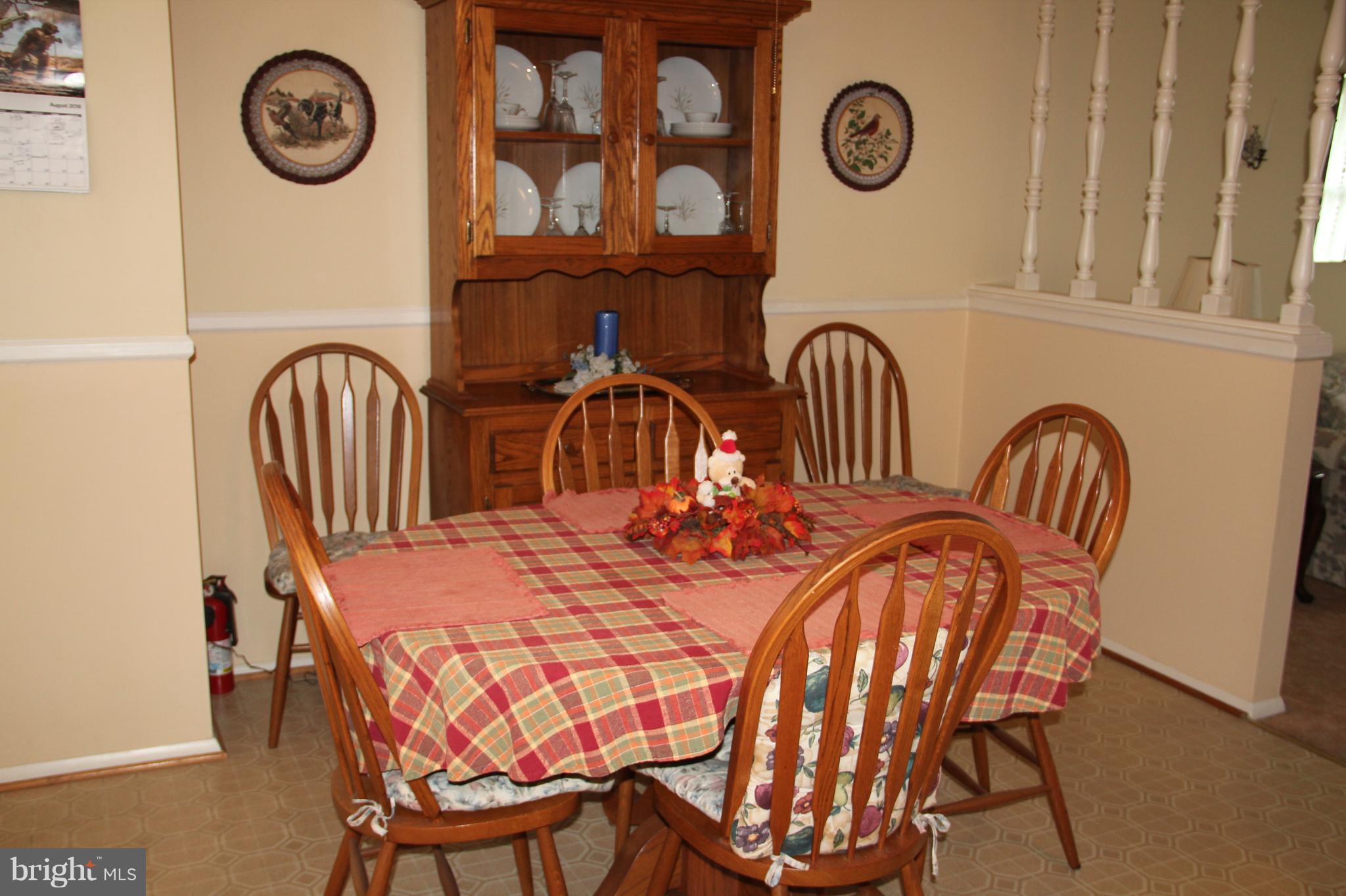 9511 Holiday Manor Road Baltimore, MD 21236 - Photo 7 of 29 a view of a dining room that has a table and a chair with the wooden floor