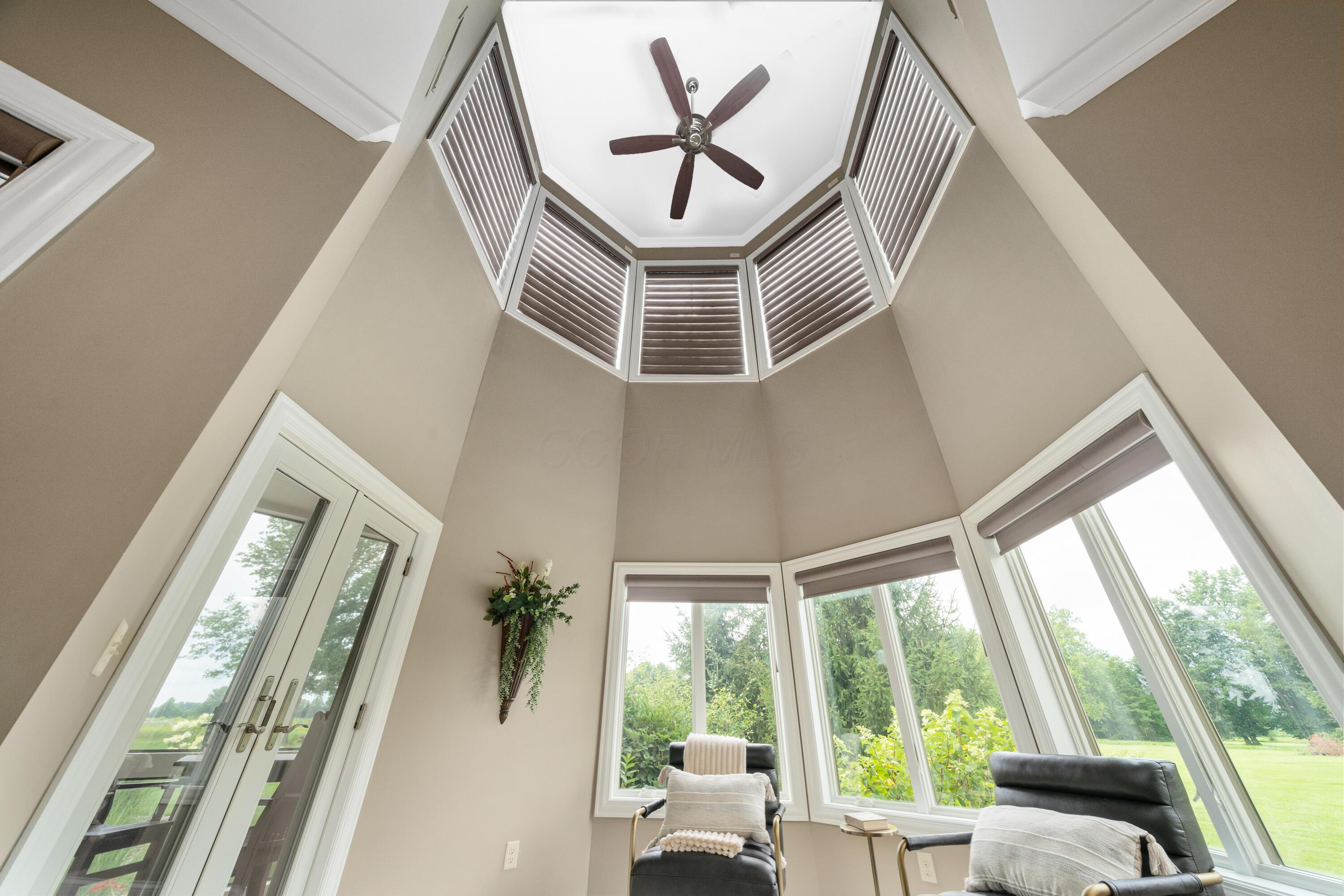 4640 Maynard Road Delaware, OH 43015 - Photo 33 of 91 Vaulted ceiling with a ceiling fan, crown molding, and upper-level windows featuring louvered blinds