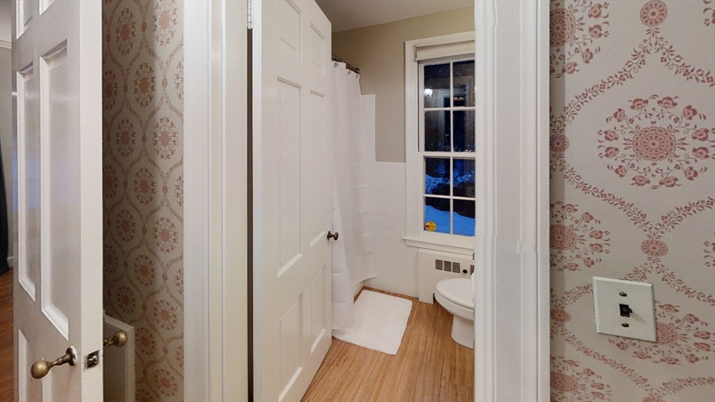 78 Draper Road Wayland, MA 01778 - Photo 12 of 14 a view of a hallway with wooden floor and closet