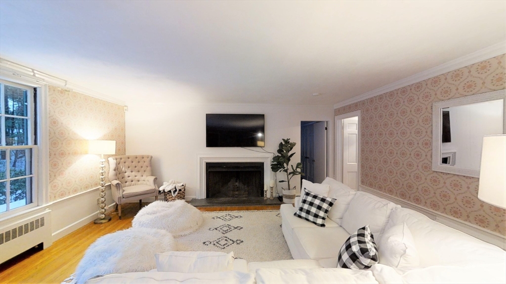 78 Draper Road Wayland, MA 01778 - Photo 2 of 14 a living room with furniture a flat screen tv and a fireplace