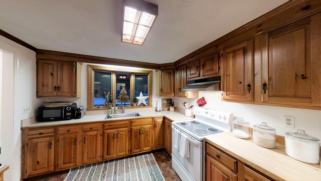 78 Draper Road Wayland, MA 01778 - Photo 6 of 14 a kitchen with a sink stove and cabinets