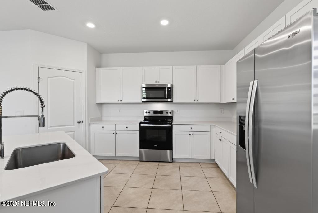 45 Seaport Breeze Road St. Augustine, FL 32095 - Photo 20 of 88 a kitchen with a sink a stove and refrigerator