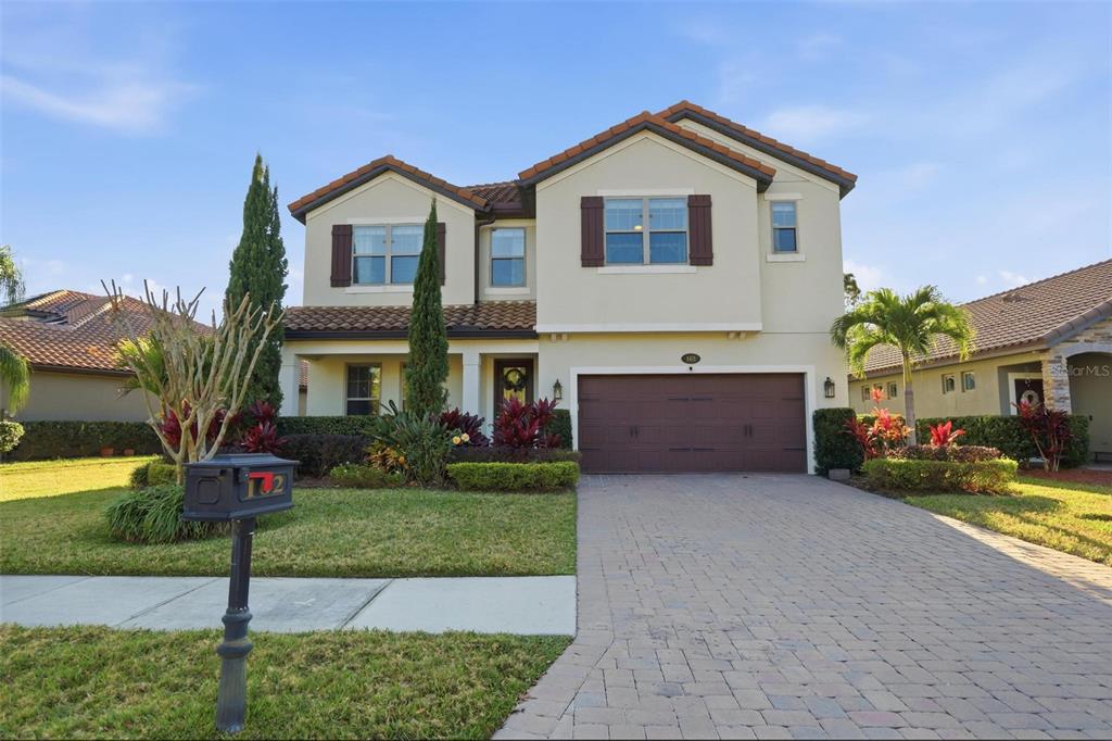 162 Ancona Avenue DeBary, FL 32713 - Photo 2 of 51 a front view of a house with a yard and garage