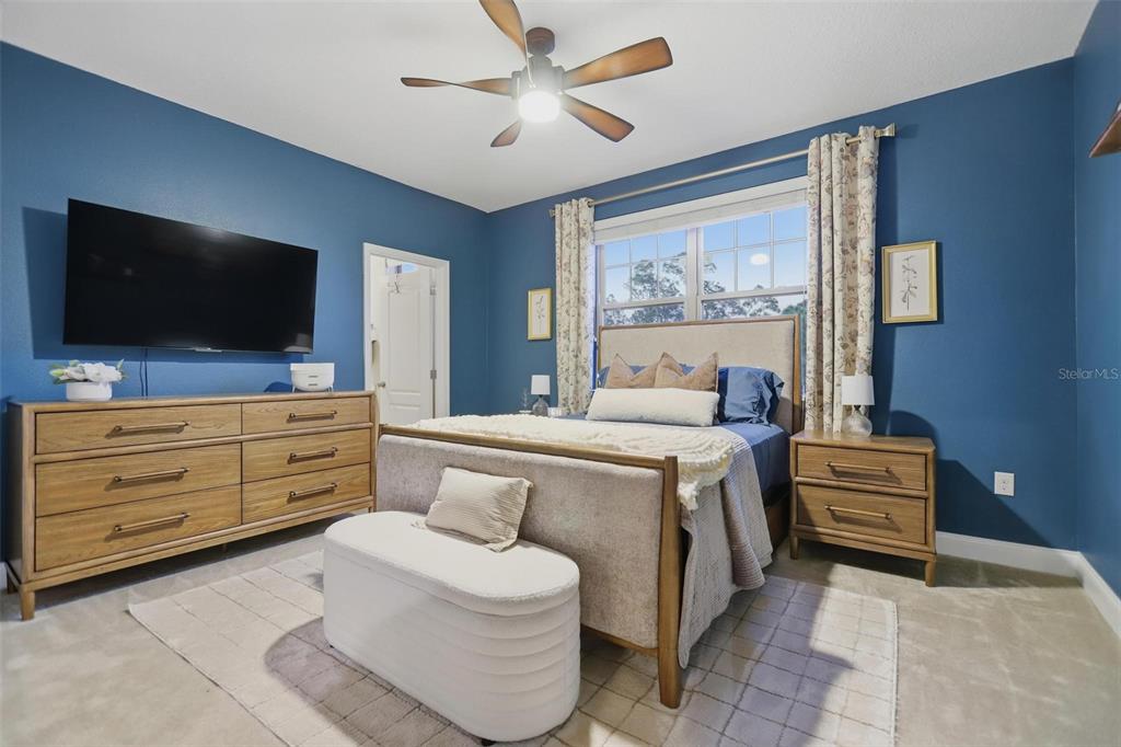 162 Ancona Avenue DeBary, FL 32713 - Photo 39 of 51 a spacious bedroom with a bed and a flat screen tv