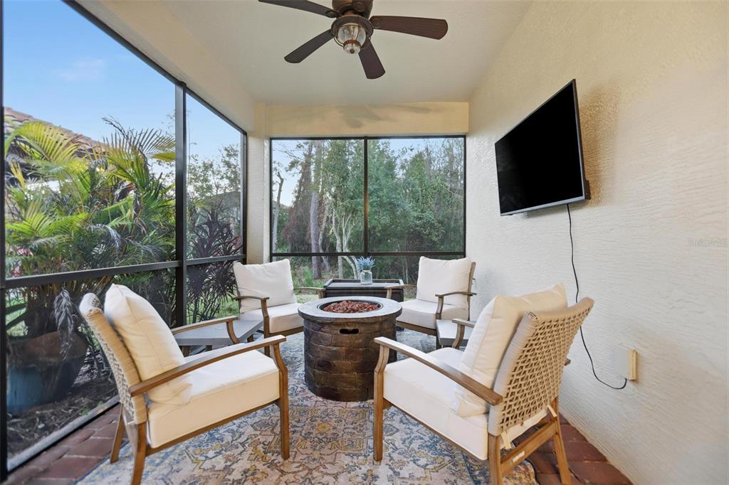 162 Ancona Avenue DeBary, FL 32713 - Photo 44 of 51 a living room with furniture floor to ceiling window hardwood floor and a flat screen tv