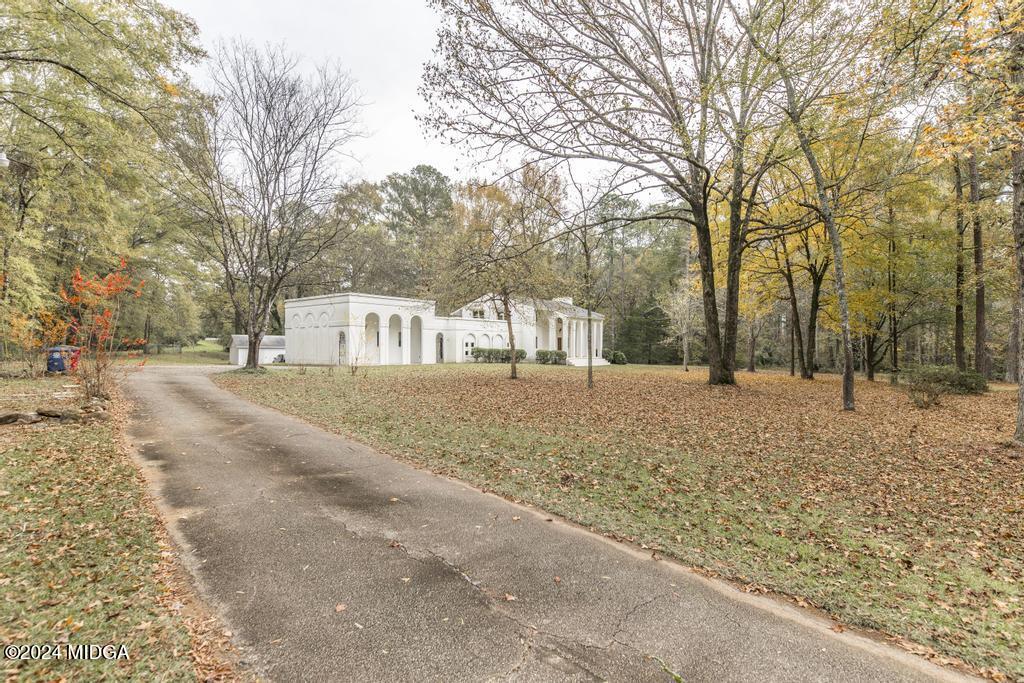 6909 Forsyth Road Macon, GA 31210 - Photo 1 of 53 a view of road with trees in the background