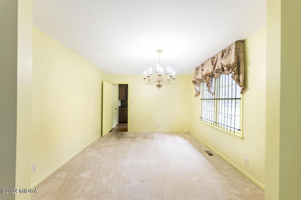 6909 Forsyth Road Macon, GA 31210 - Photo 13 of 53 a view of a livingroom with a chandelier