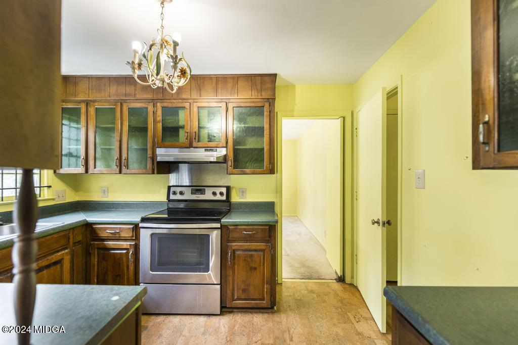 6909 Forsyth Road Macon, GA 31210 - Photo 17 of 53 a kitchen with stainless steel appliances granite countertop a stove and a refrigerator
