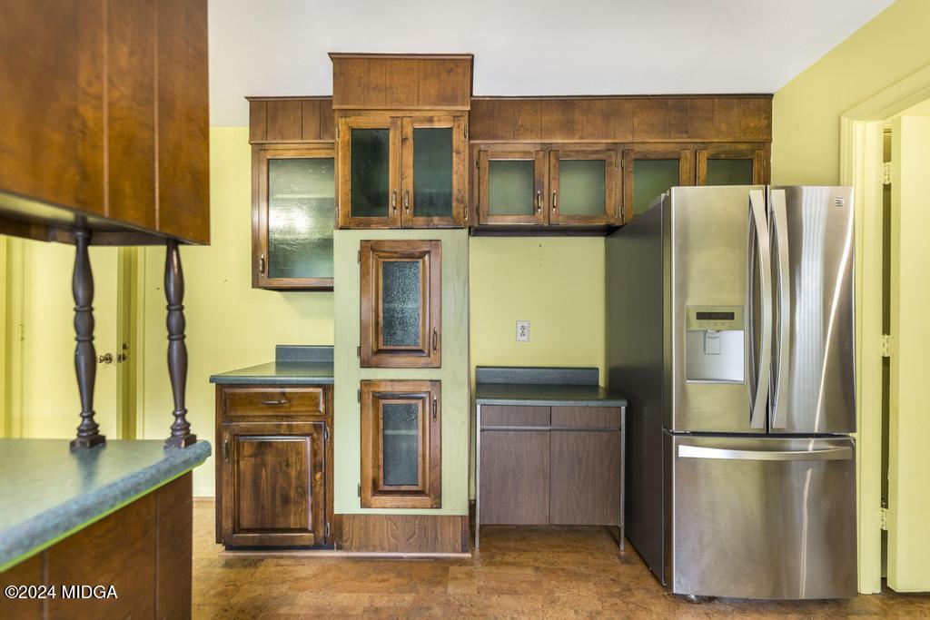 6909 Forsyth Road Macon, GA 31210 - Photo 18 of 53 a kitchen with stainless steel appliances granite countertop a refrigerator and a stove