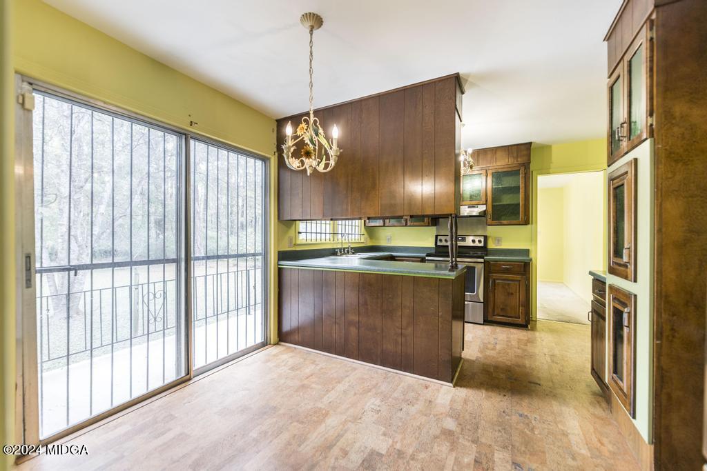 6909 Forsyth Road Macon, GA 31210 - Photo 19 of 53 a kitchen with stainless steel appliances granite countertop a refrigerator a oven a sink and a stove