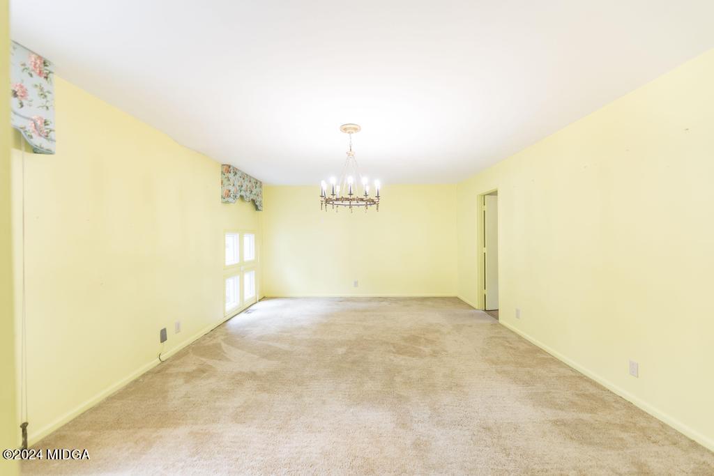 6909 Forsyth Road Macon, GA 31210 - Photo 21 of 53 a view of a big room with windows