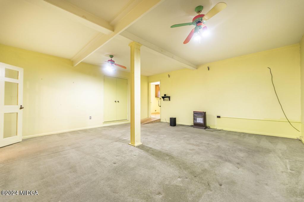 6909 Forsyth Road Macon, GA 31210 - Photo 23 of 53 an empty room with ceiling fan and window