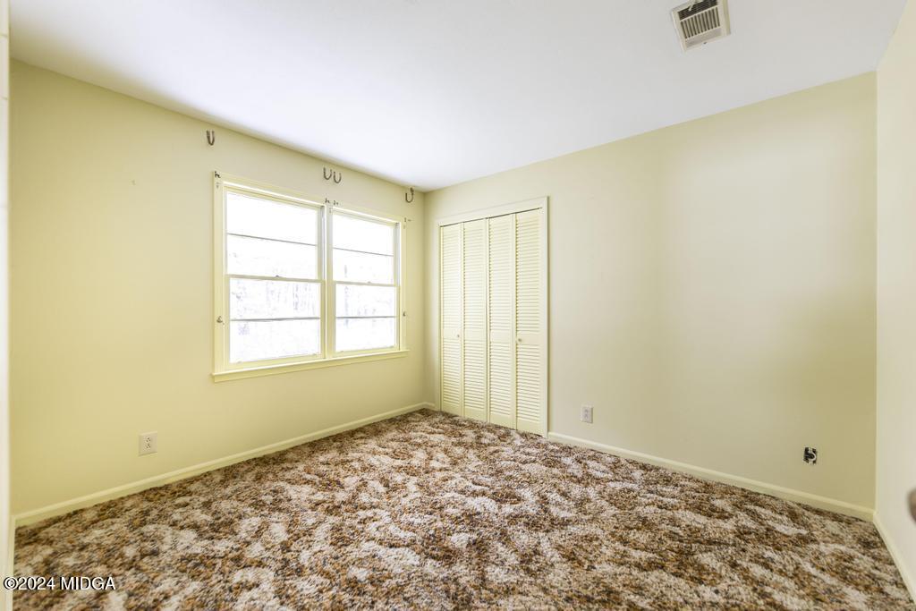 6909 Forsyth Road Macon, GA 31210 - Photo 42 of 53 a view of a big room with wooden floor and a window