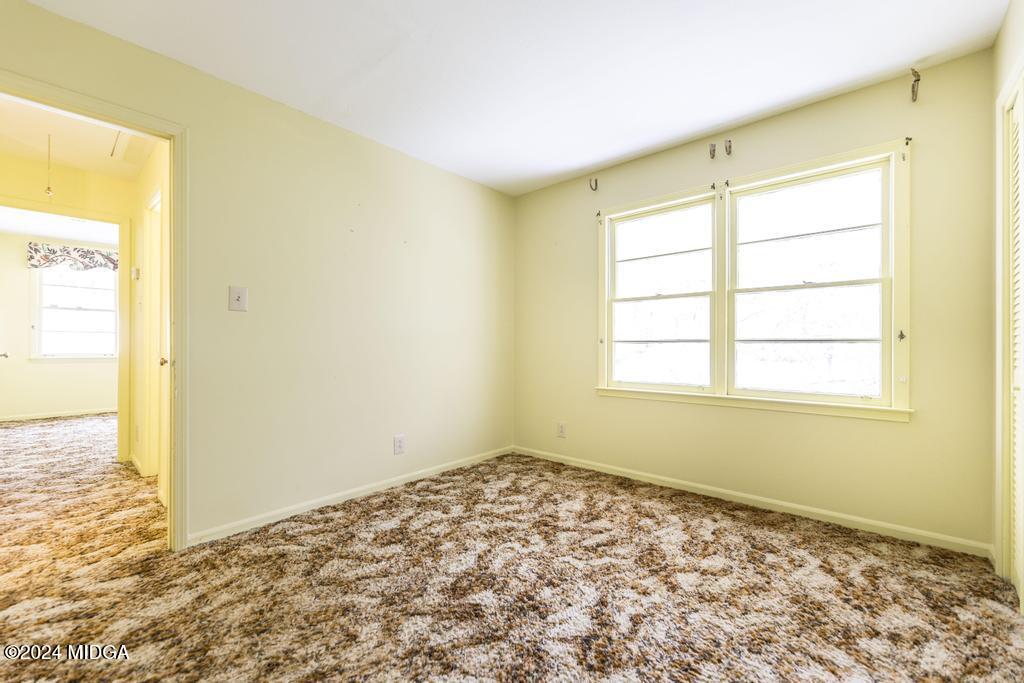 6909 Forsyth Road Macon, GA 31210 - Photo 43 of 53 a view of an empty room with a window