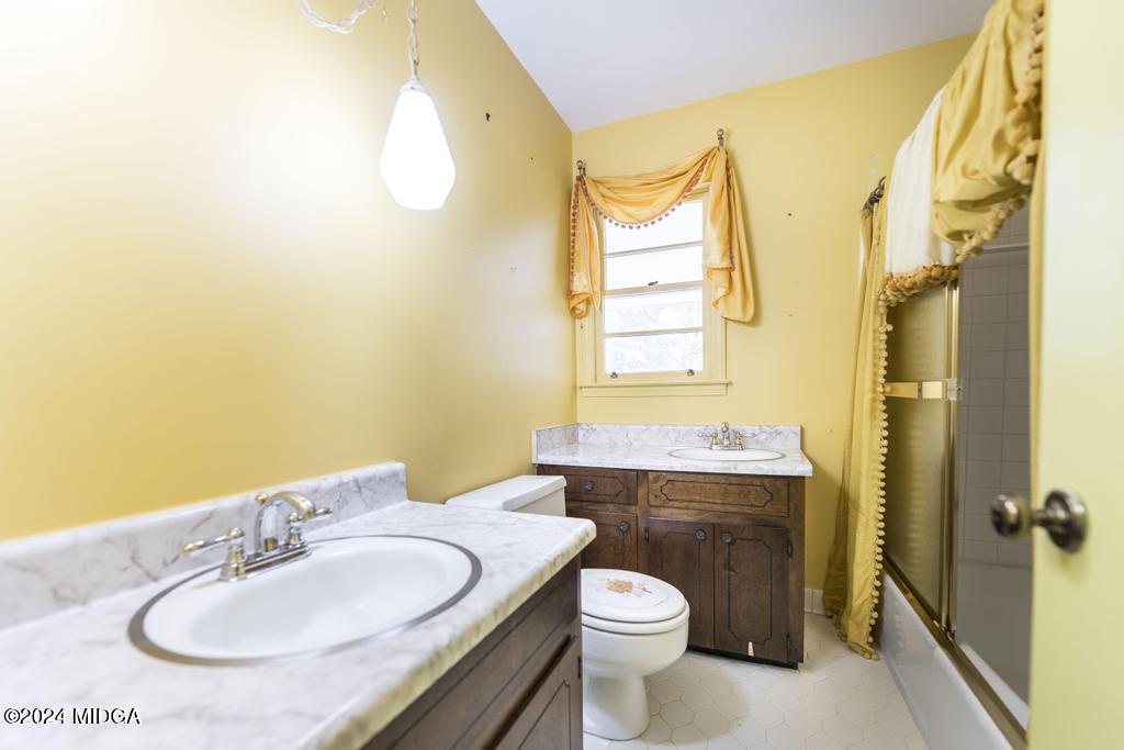 6909 Forsyth Road Macon, GA 31210 - Photo 44 of 53 a bathroom with a sink and a mirror