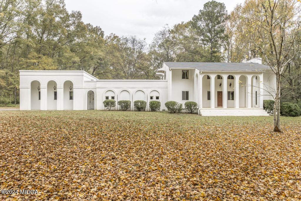 6909 Forsyth Road Macon, GA 31210 - Photo 5 of 53 a view of a white house with a yard