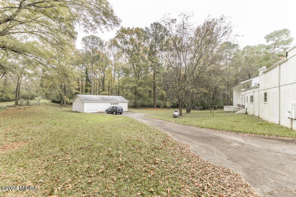 6909 Forsyth Road Macon, GA 31210 - Photo 53 of 53 a house with trees in front of it