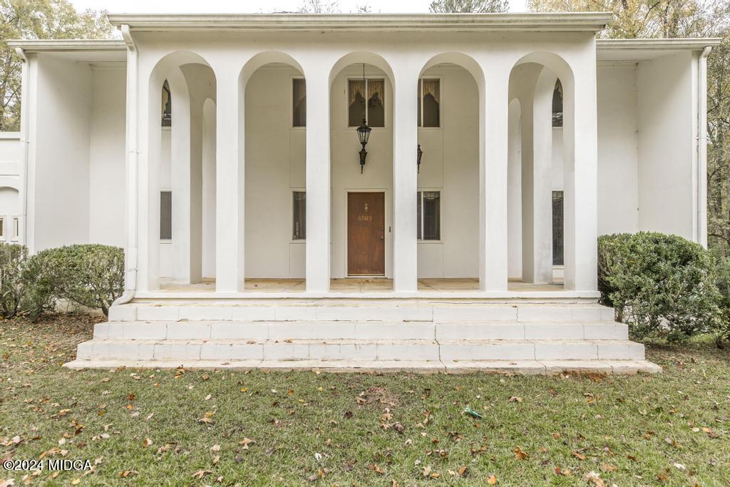6909 Forsyth Road Macon, GA 31210 - Photo 8 of 53 a front view of a house with white doors