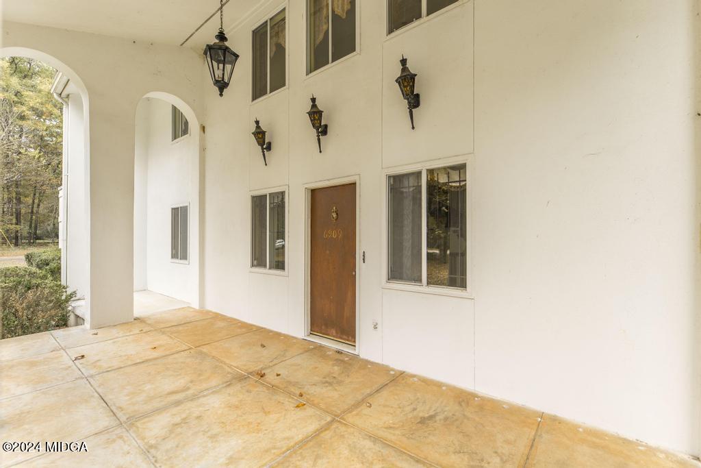 6909 Forsyth Road Macon, GA 31210 - Photo 9 of 53 a view of a white house with a large window