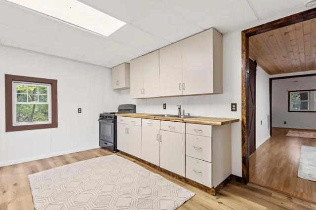 a kitchen with granite countertop white cabinets and white appliances