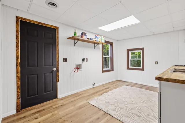 a view of a livingroom with wooden floor and windows
