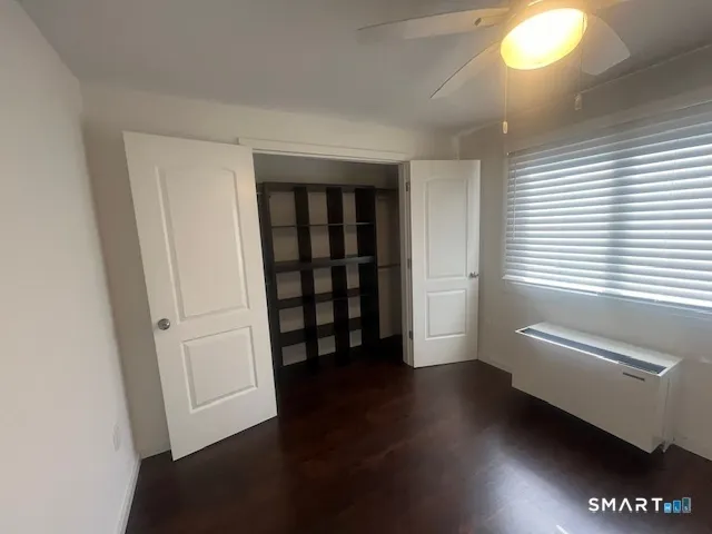 a view of wooden floor and windows in a room