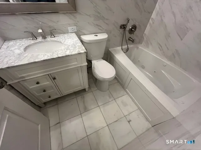 a bathroom with a sink a toilet and bathtub